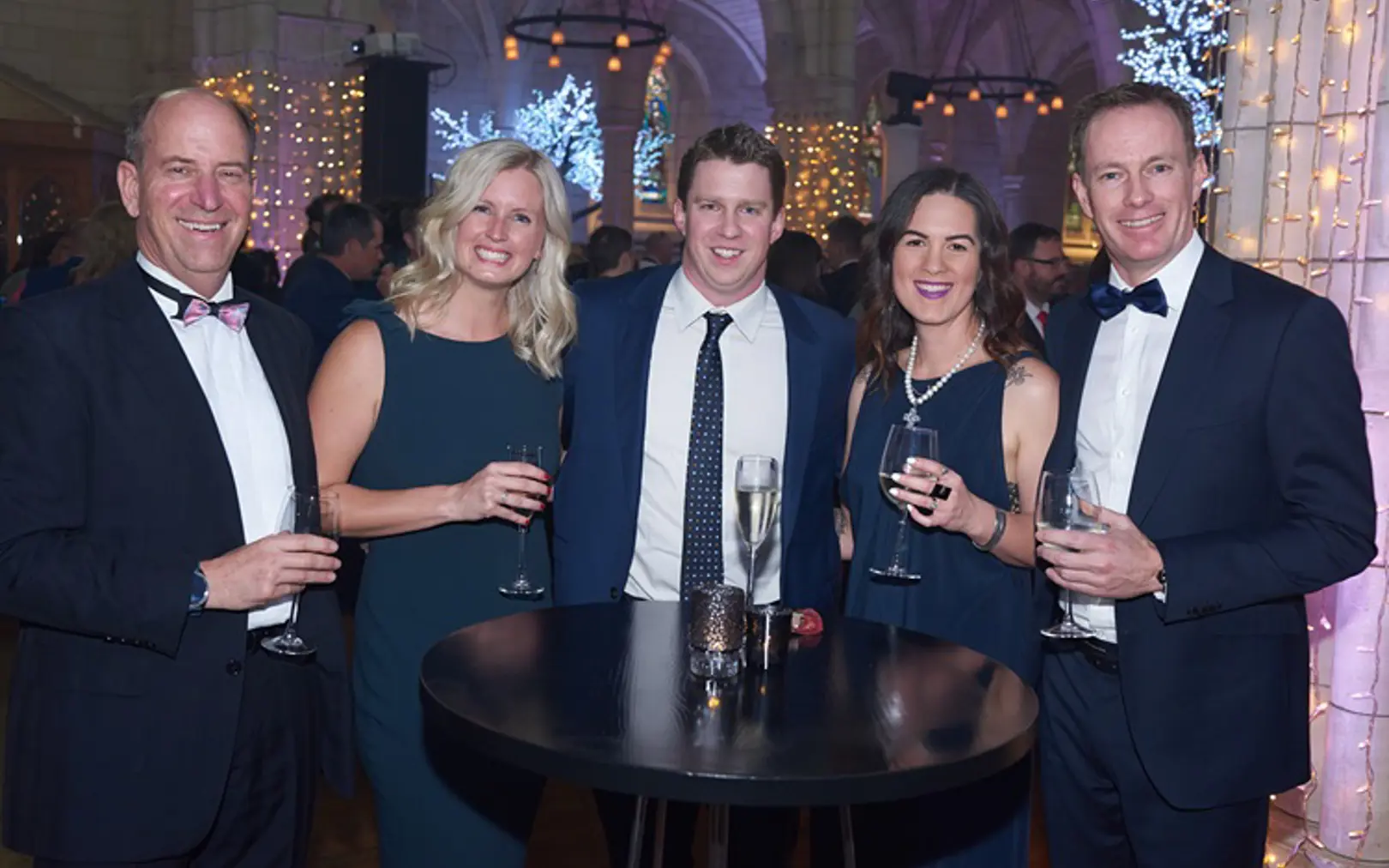 The team at Enlighten celebrating round a table at the Microsoft NZ Partner Awards in 2019