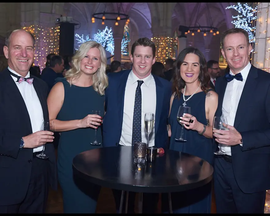 The team at Enlighten celebrating round a table at the Microsoft NZ Partner Awards in 2019