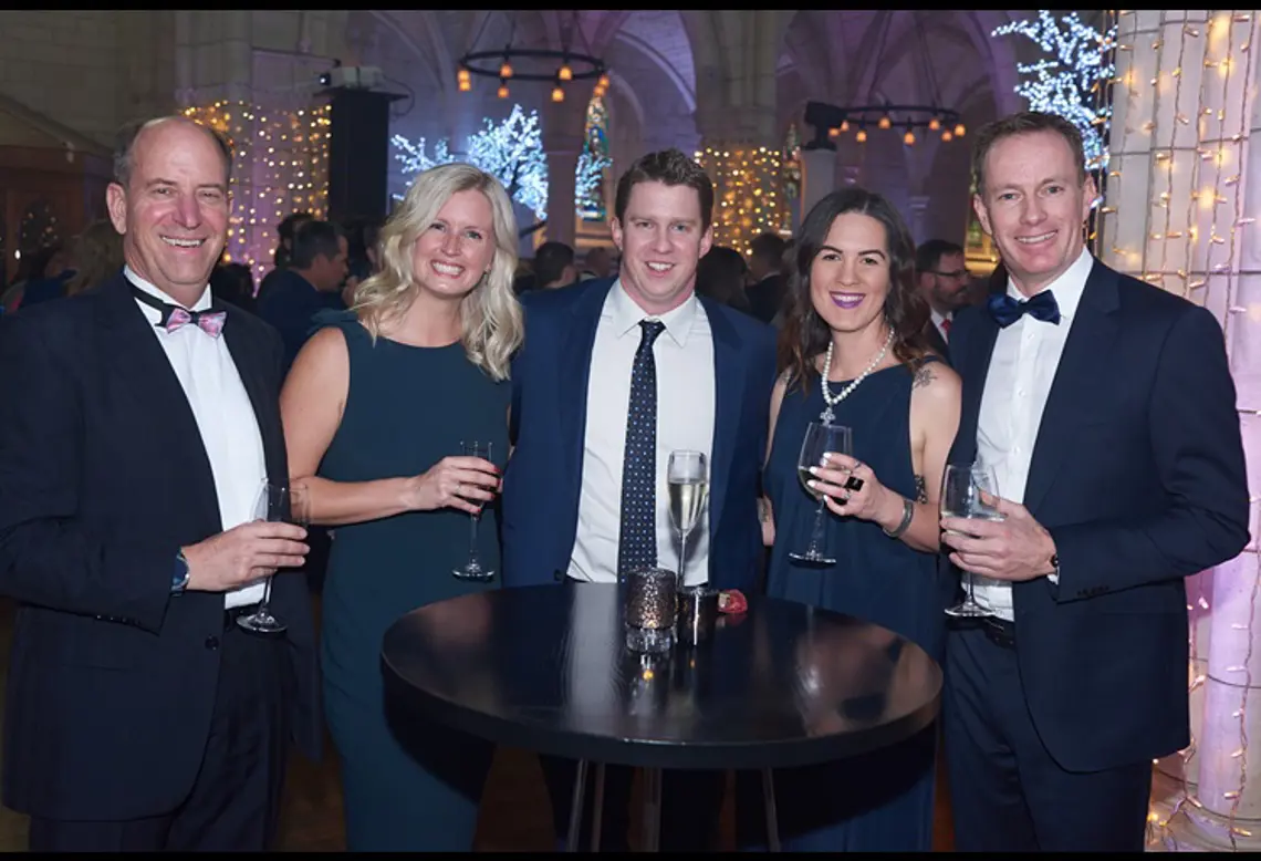 The team at Enlighten celebrating round a table at the Microsoft NZ Partner Awards in 2019
