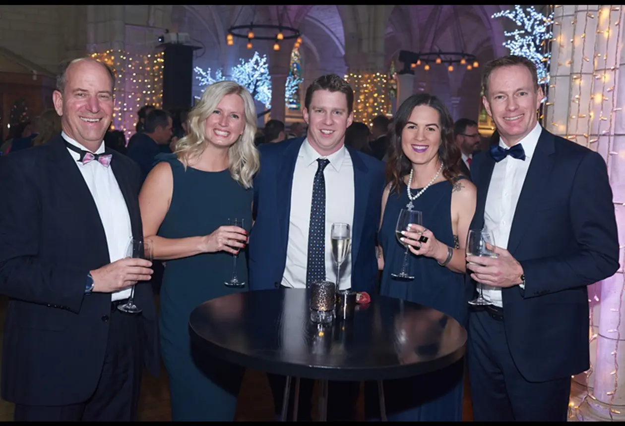 The team at Enlighten celebrating round a table at the Microsoft NZ Partner Awards in 2019