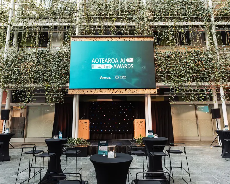 a stage with tables and chairs in front of a building