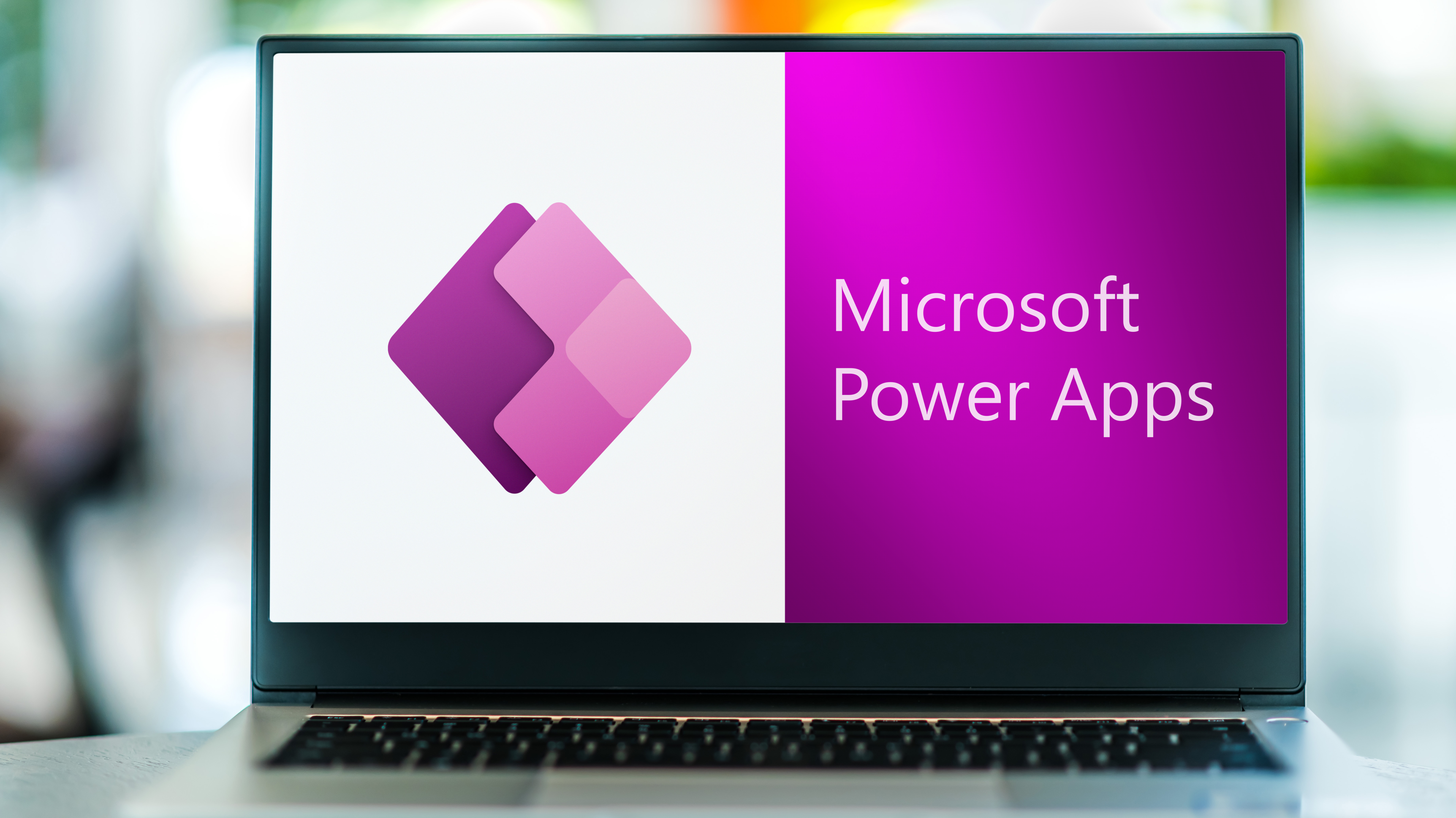 a laptop with power apps logo on it