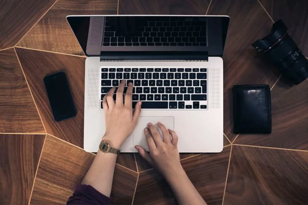 a person typing on a laptop