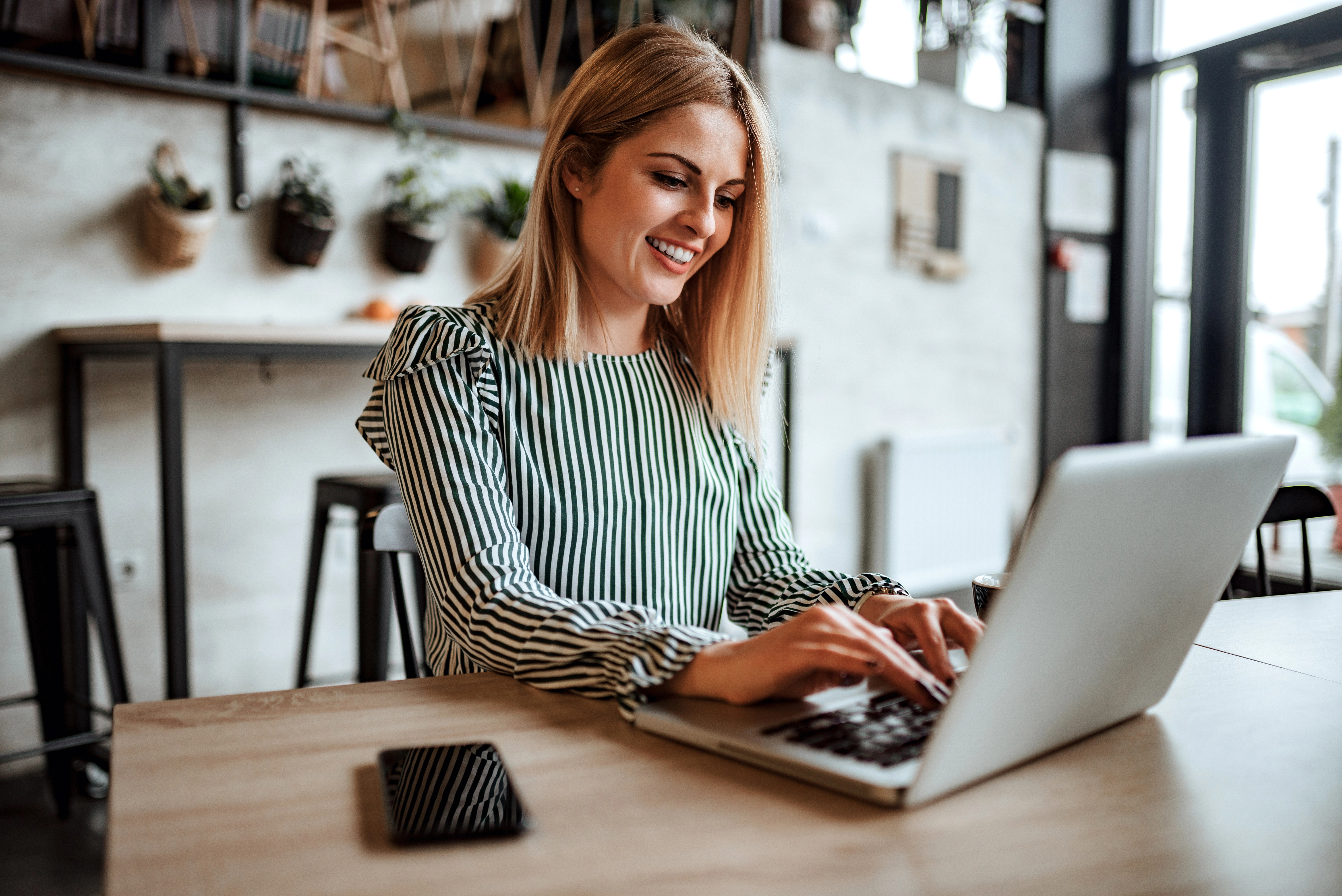 a woman using a laptop for customer journey strategy