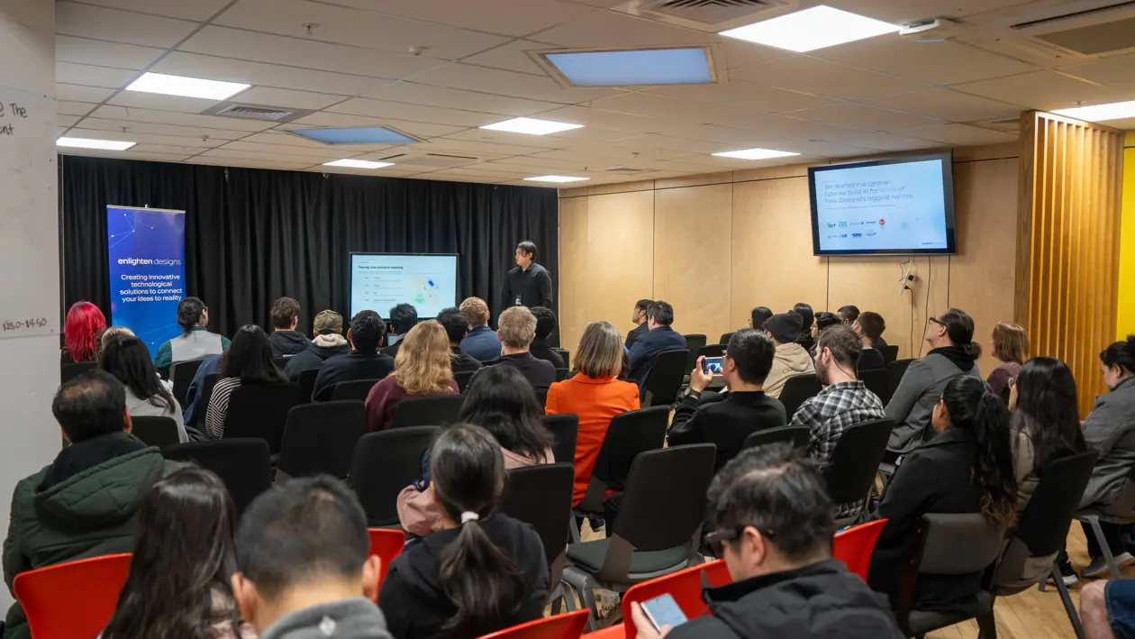 a man standing in front of a group of people in a room