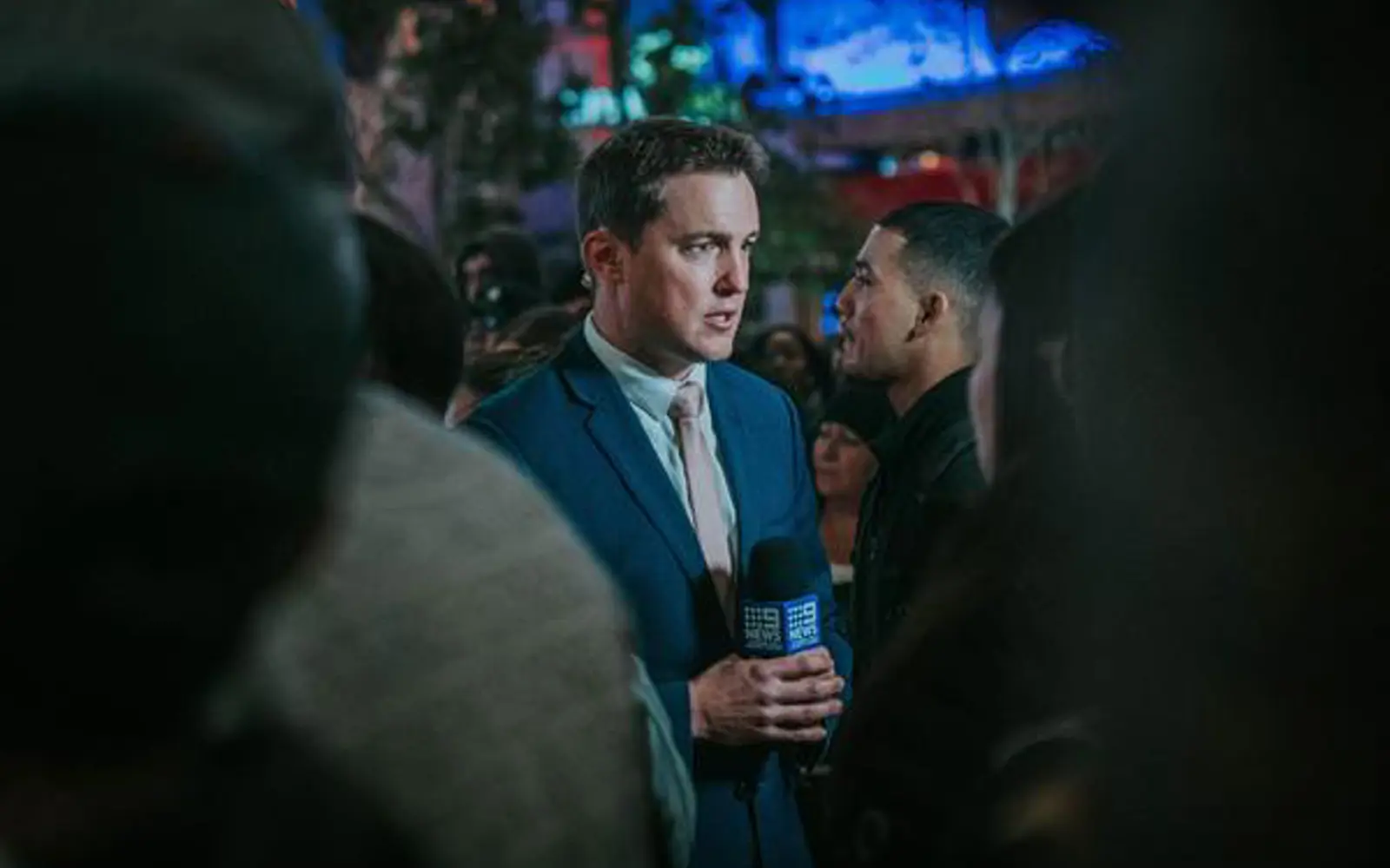 a man in a suit holding a microphone