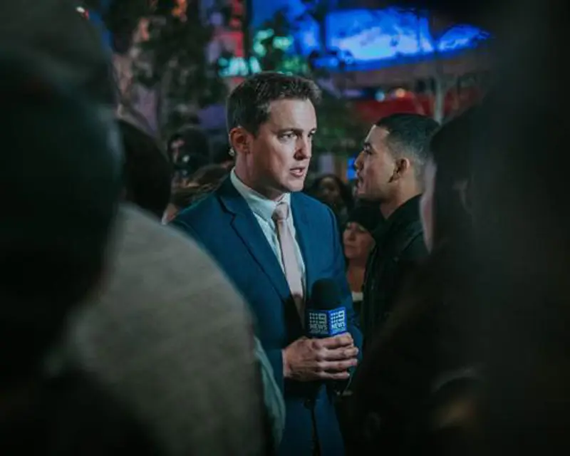 a man in a suit holding a microphone