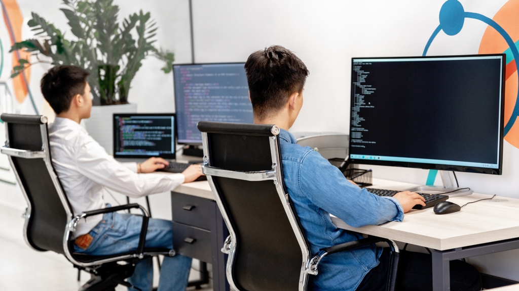 a man sitting at a desk with a computer