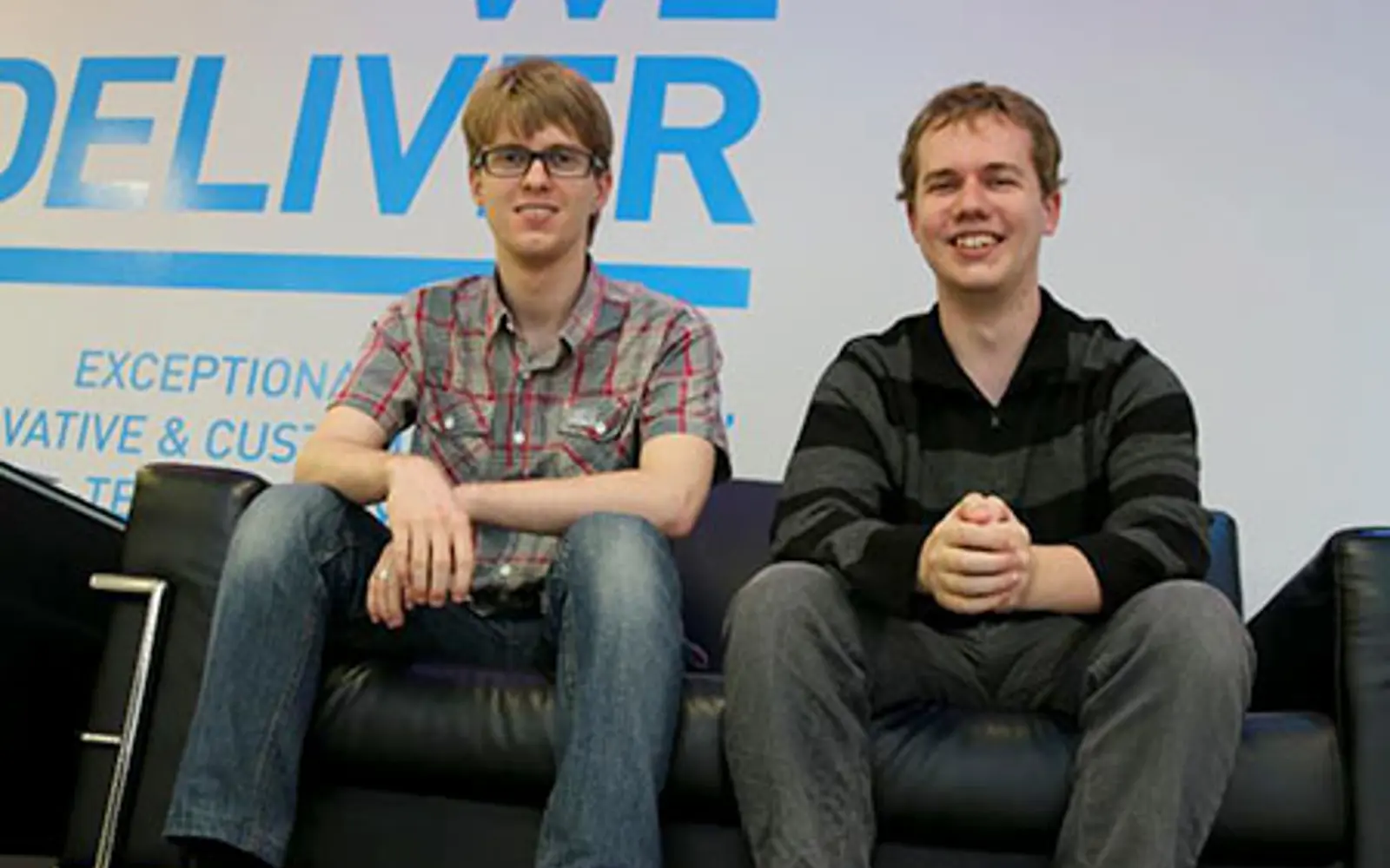 two men sitting on a couch