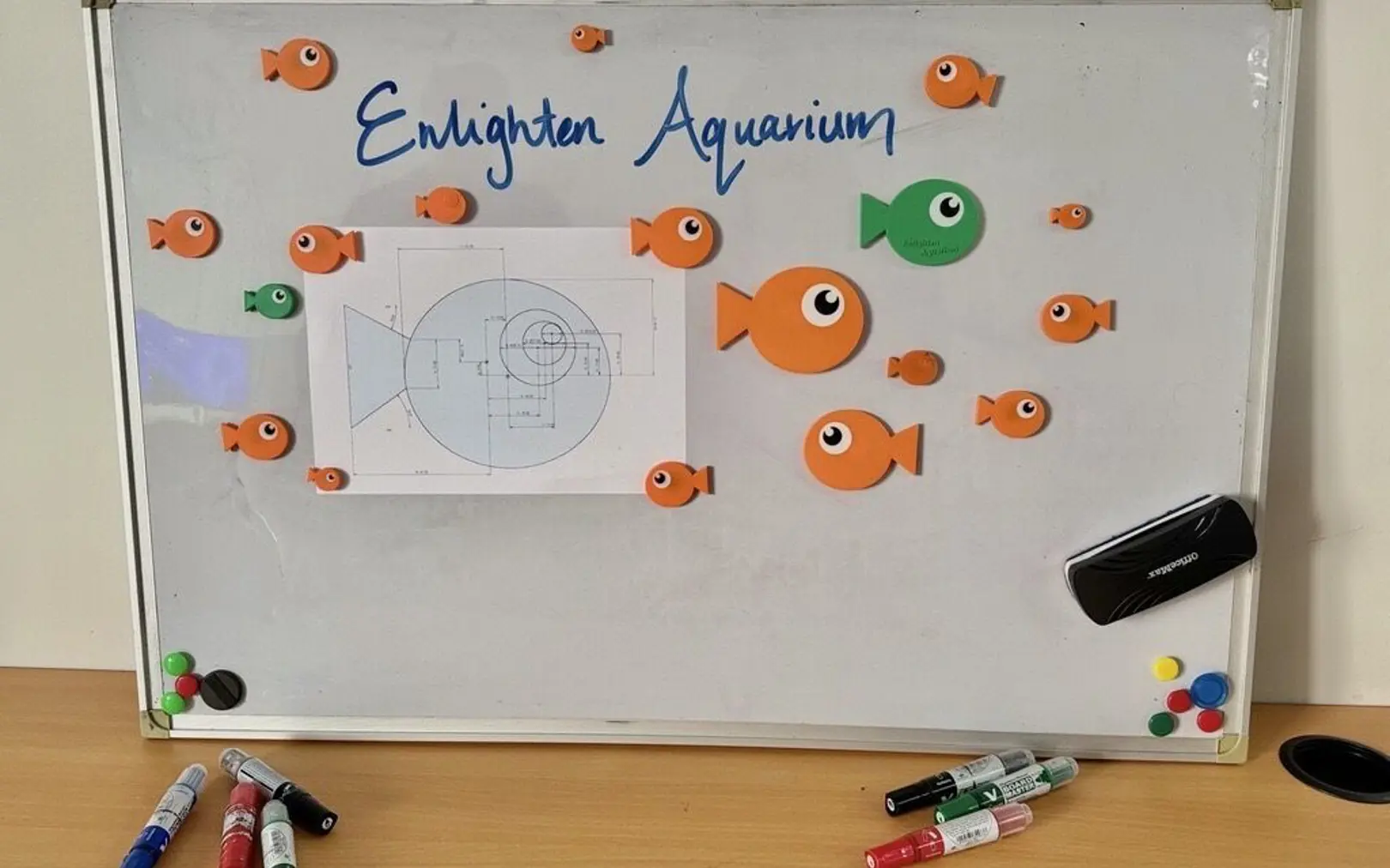 a white board with magnets and fish on it