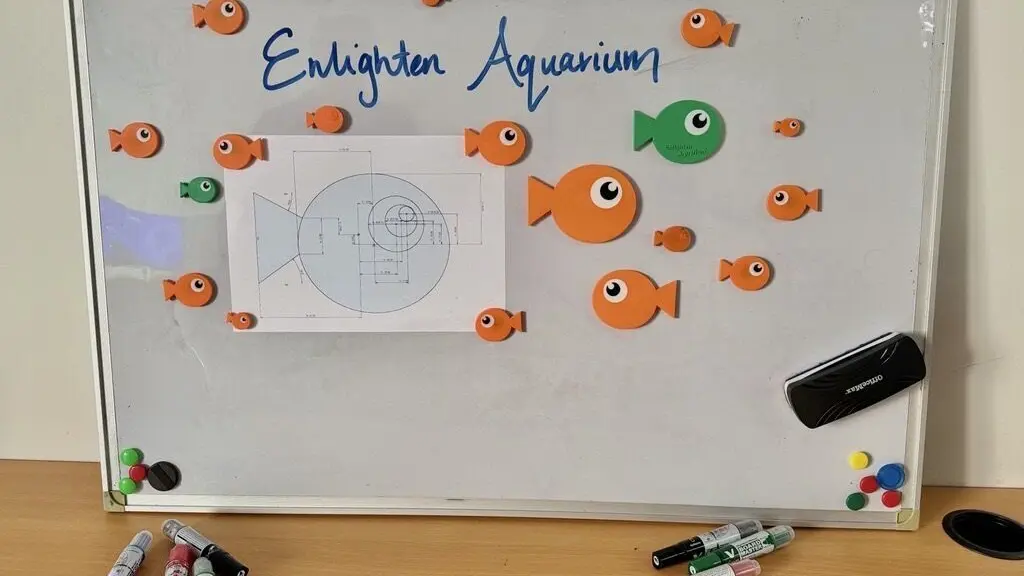 a white board with magnets and fish on it