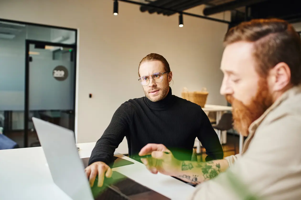 a man sitting at a table with a laptop