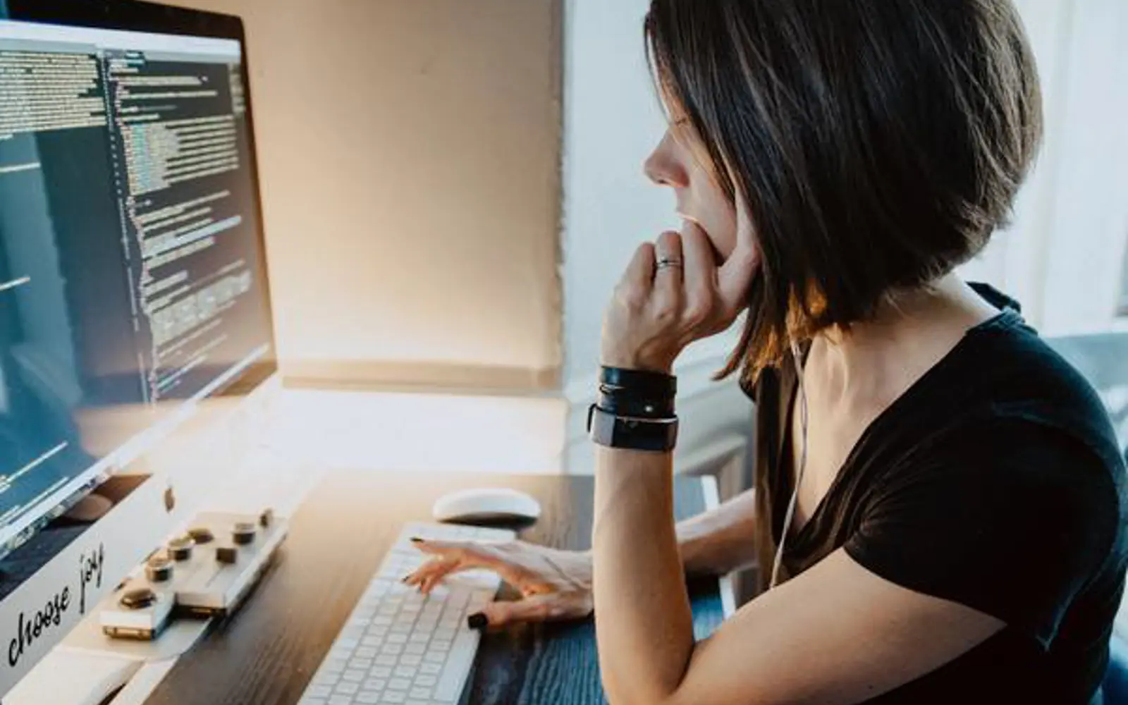 a woman sitting at a desk using a computer