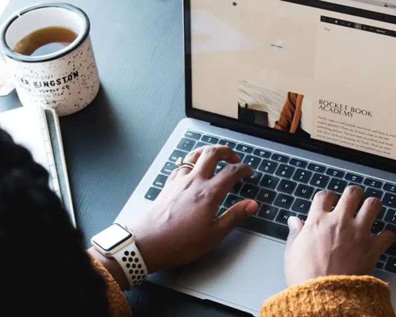 a person typing on a laptop