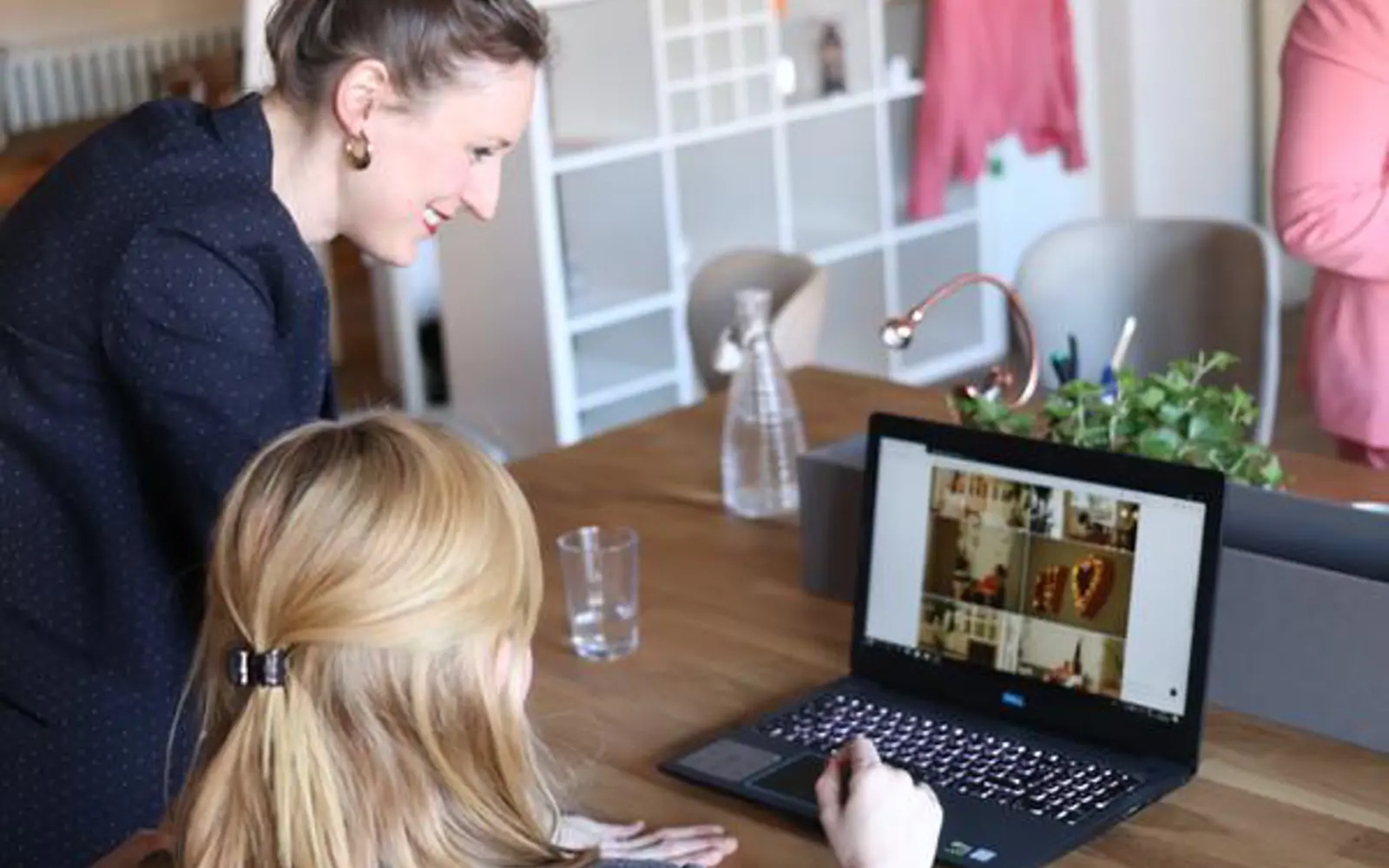 a woman looking at a laptop