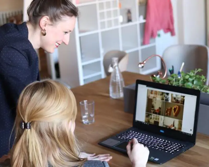 a woman looking at a laptop