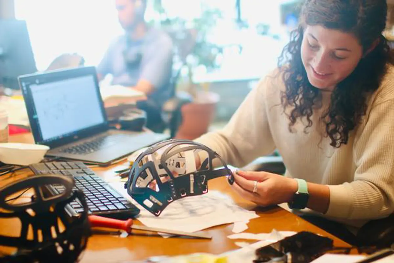 a woman working on a helmet