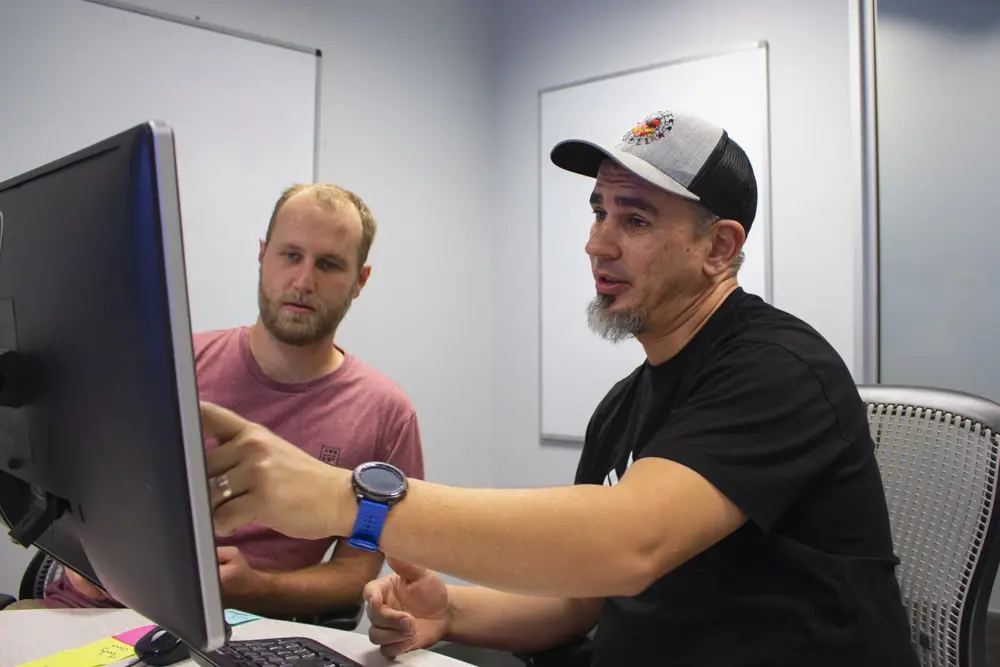 a man pointing at a computer screen