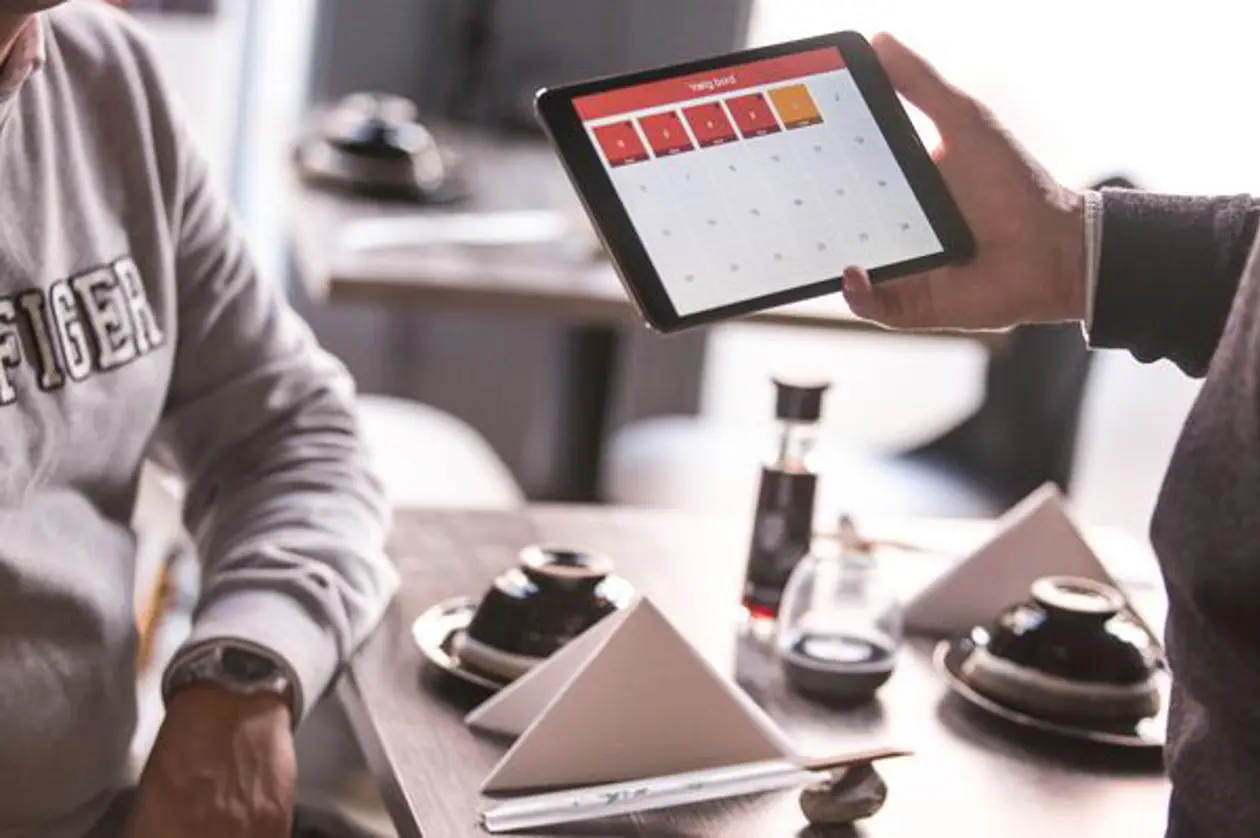 a person holding a tablet