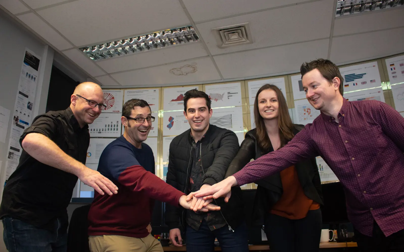 a group of people holding hands together
