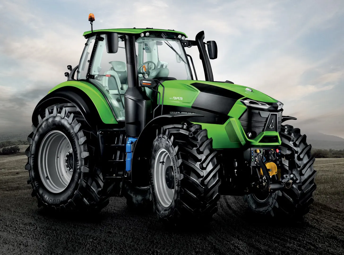 a green tractor with large wheels
